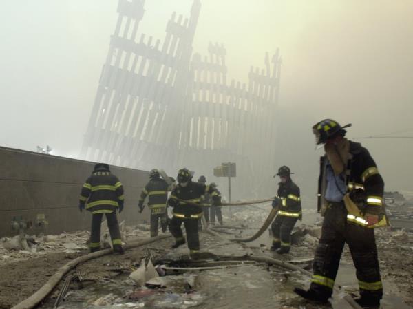 Firefighters work beneath the destroyed mullions, the vertical struts, of the World Trade Center's twin towers.